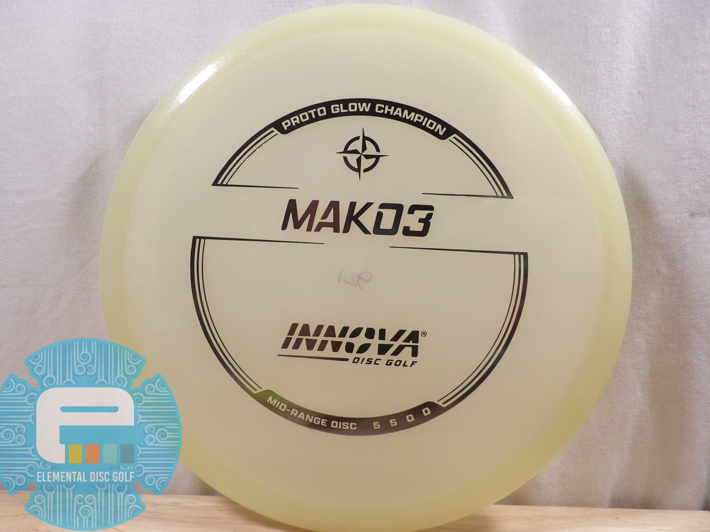 Yellow disc golf disc with 'Innova' branding on a white background