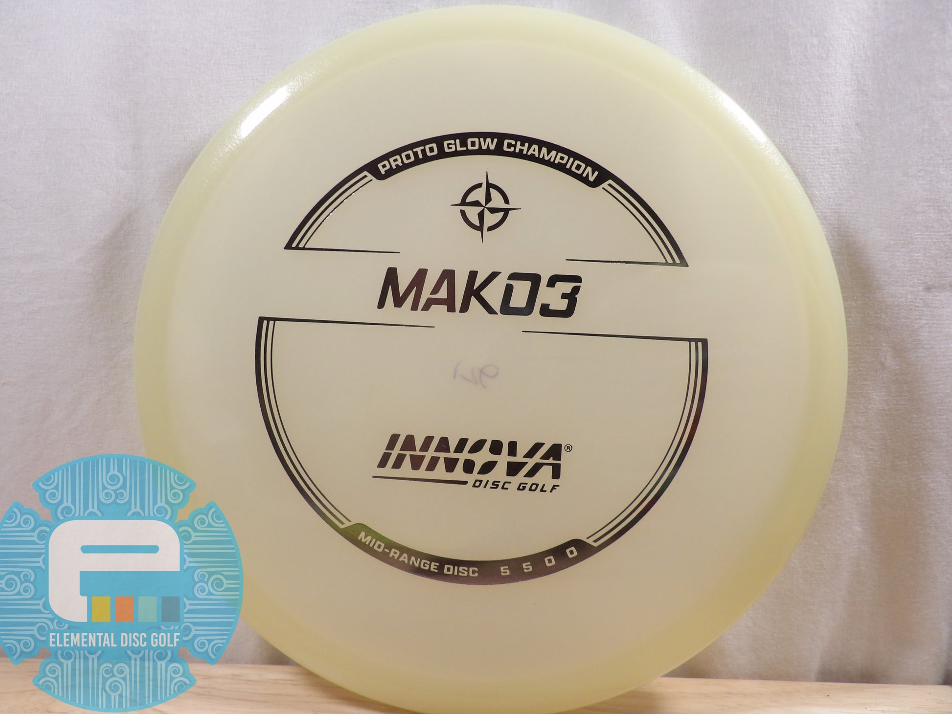 Yellow disc golf disc with 'Innova' branding on a white background